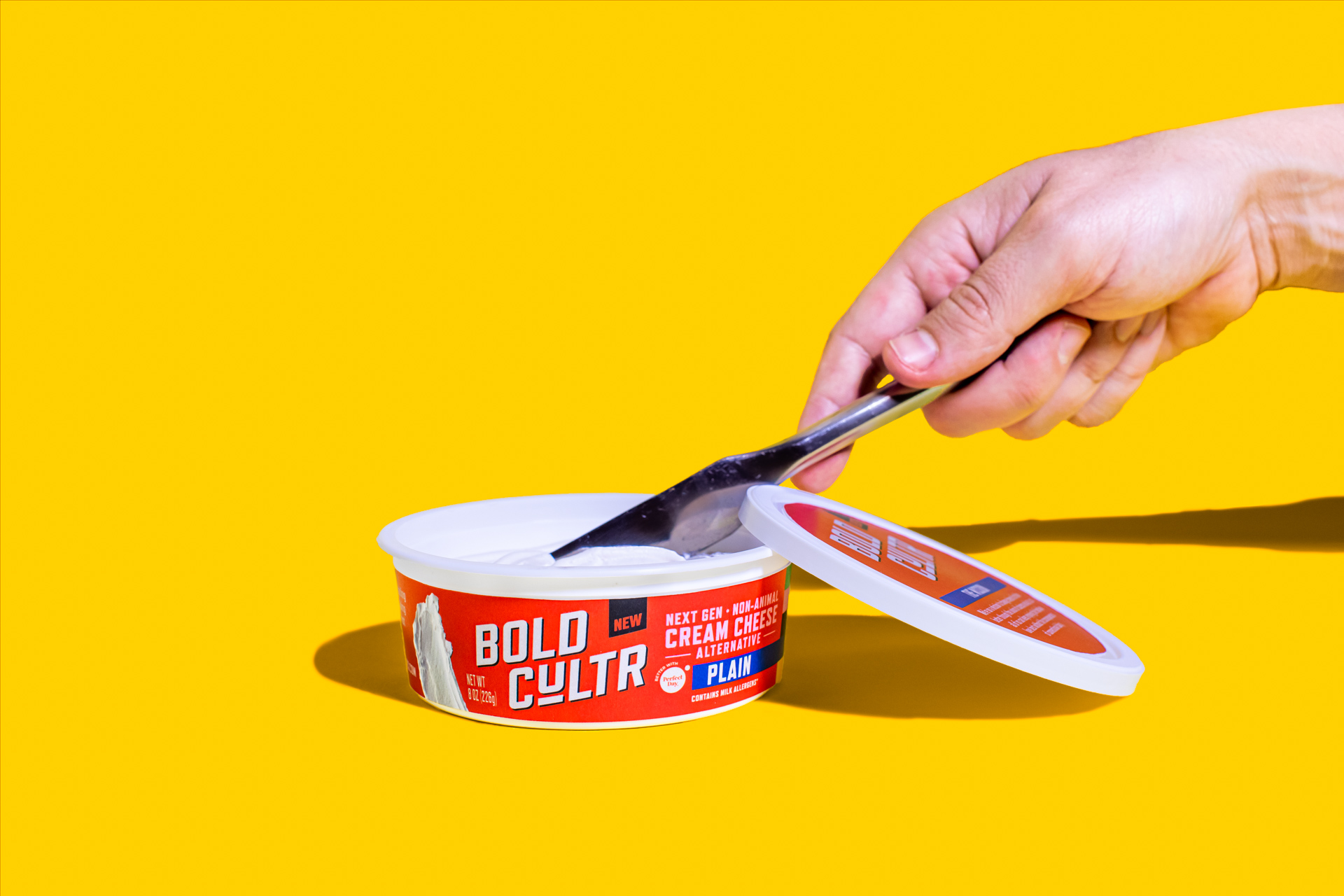 Bold Cultr cream cheese with hand
